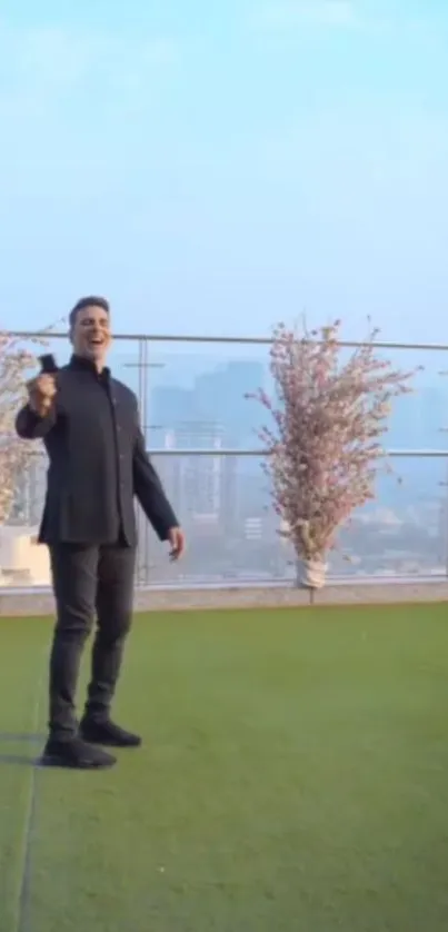 Man on grassy balcony with city view holding ice cream.