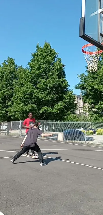 Urban basketball court with players under blue sky.