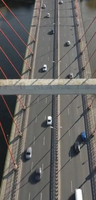 Aerial view of a busy urban bridge with cars passing over a river.