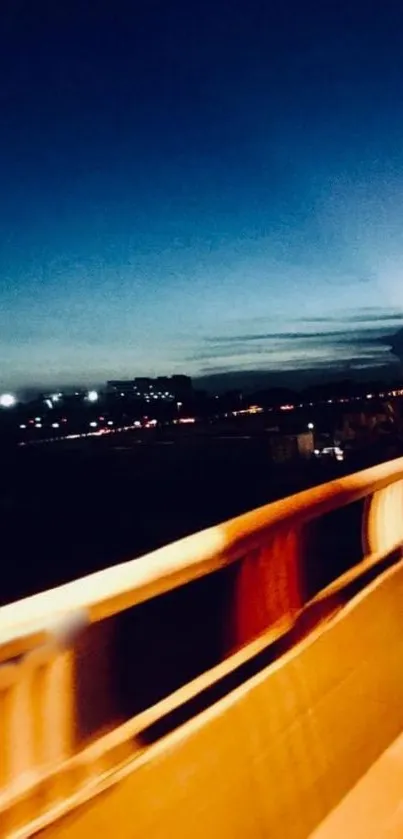 A serene urban bridge at night with city lights and dusk sky.