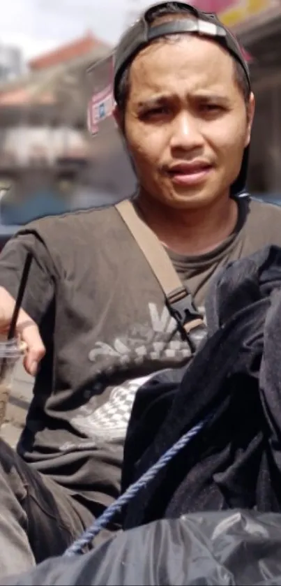 Casual man with coffee in an urban street setting.