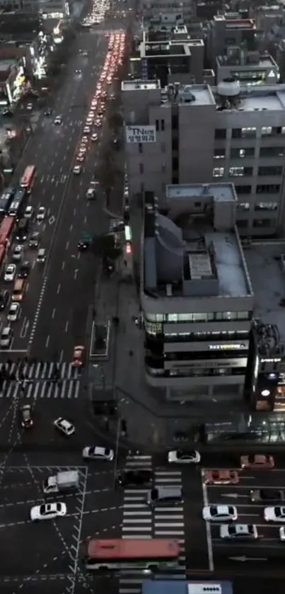 Aerial view of a busy city street at night with illuminated traffic lights.