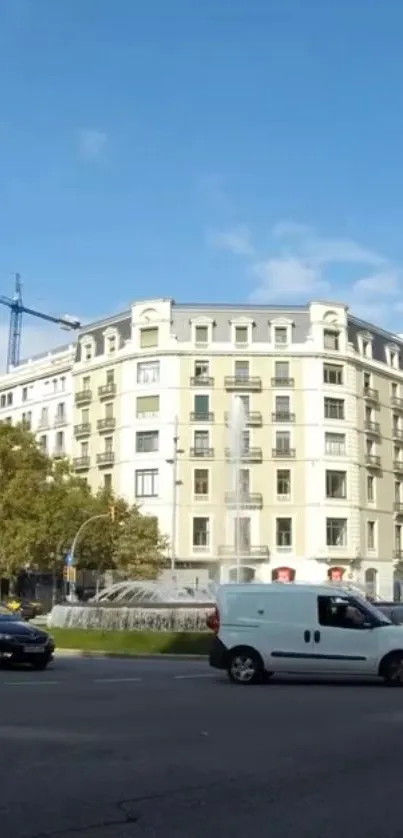 Urban cityscape with classic building and street traffic set against a blue sky.