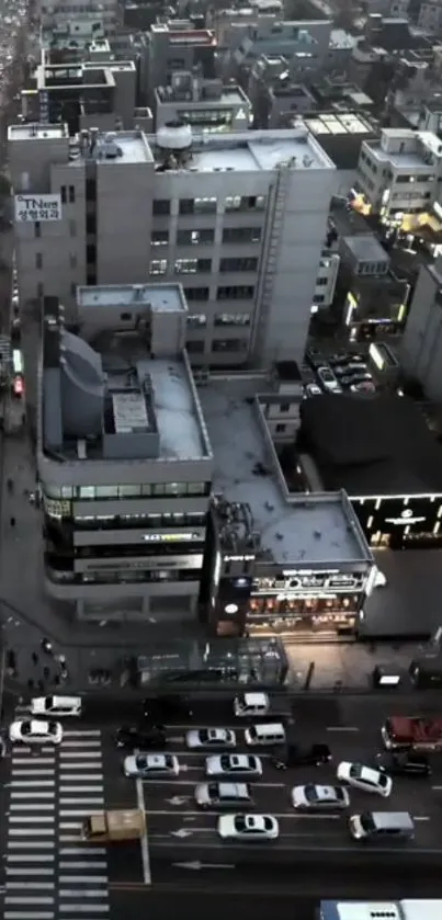 Aerial view of bustling city streets at night with illuminated buildings.