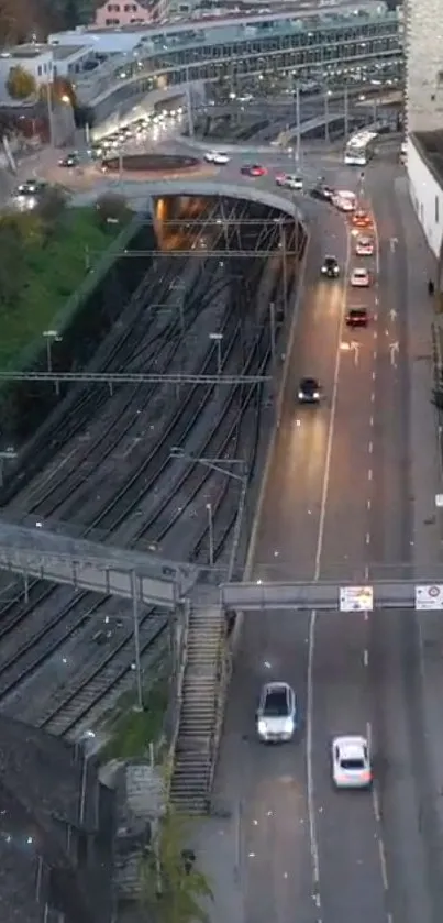 Aerial view of city road with cars and rail tracks.