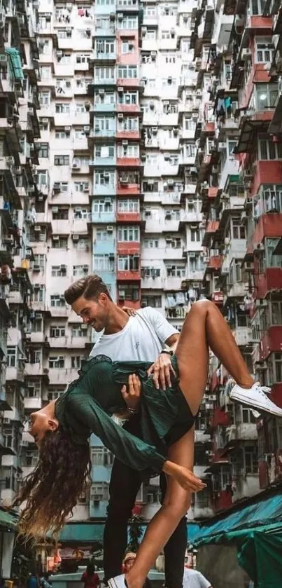 Couple dancing in an urban alley with towering buildings.