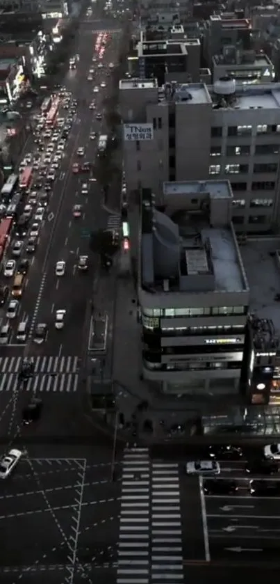 Aerial view of city at dusk with traffic and lights on the streets.