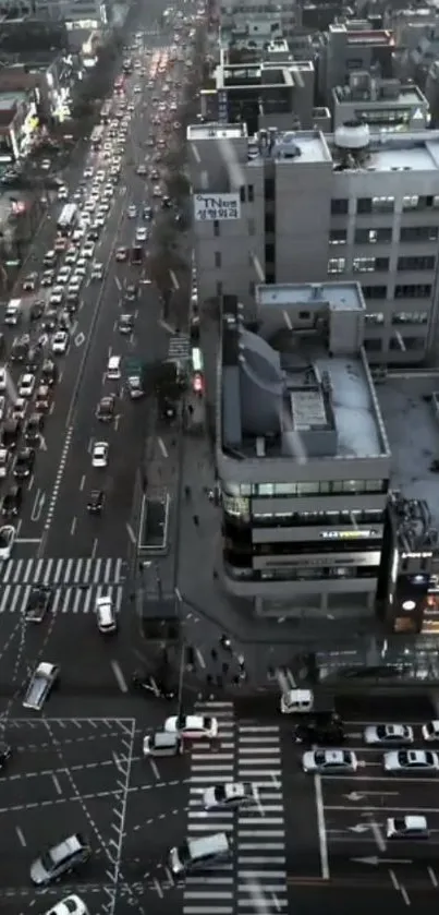 Aerial evening view of a bustling city street with traffic and skyscrapers.