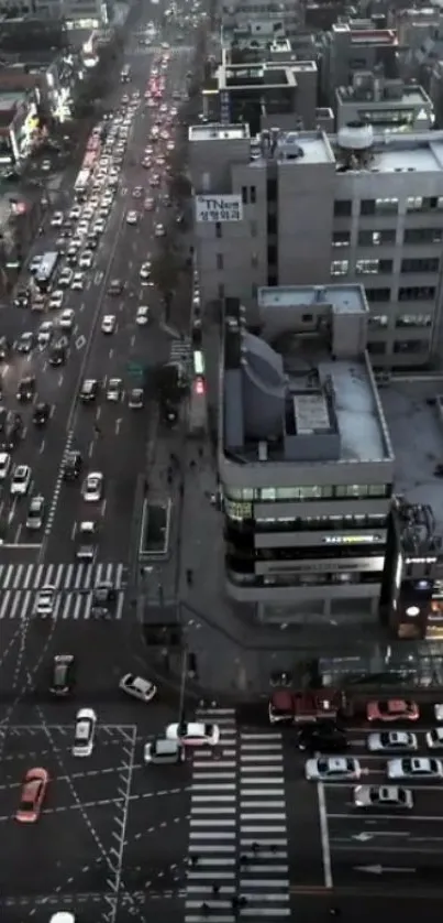 Aerial city view with bustling streets and bright evening lights.