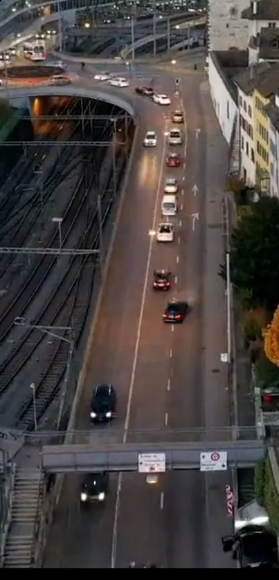 Aerial city view showing evening traffic and illuminated urban roads.