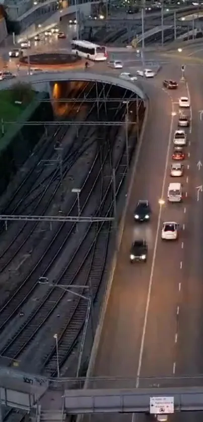 Evening city traffic with cars moving under streetlights on a roadway.