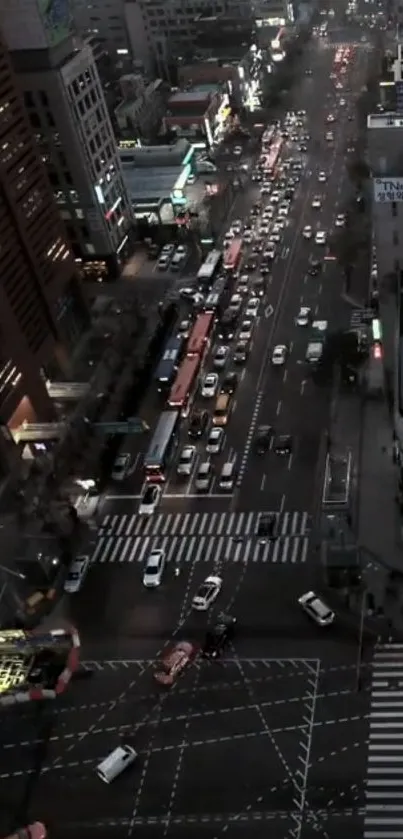 Aerial view of evening city traffic with glowing lights and bustling streets.