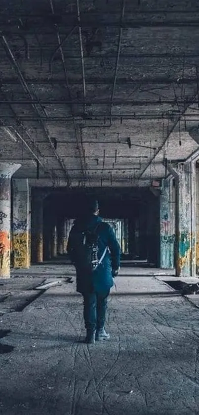 Lone figure walking through an abandoned industrial building.