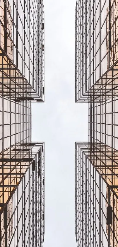 Symmetrical buildings with geometric design and sky reflection.