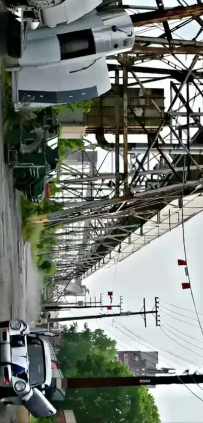 Vintage car under industrial metal structure on urban roadside.