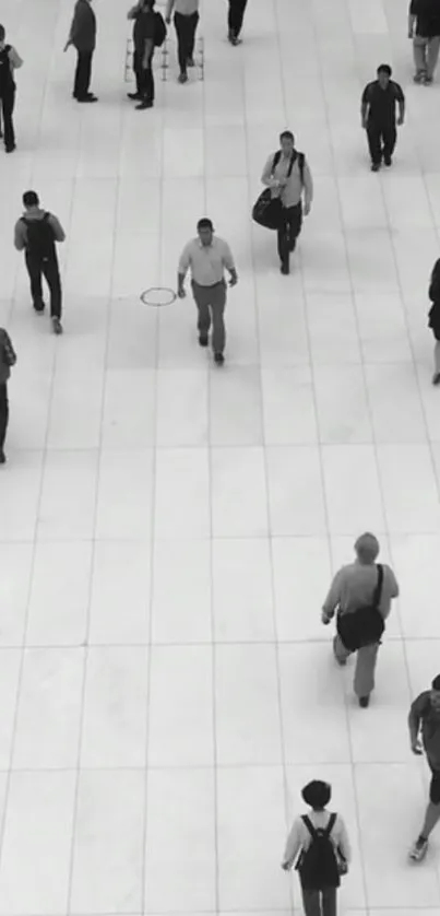 Black and white urban scene with people walking on a tiled floor.