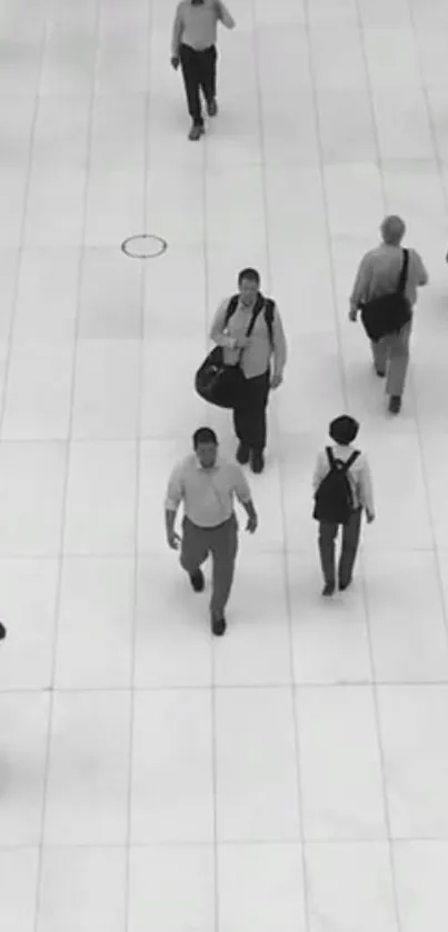 Black and white urban scene with pedestrians on a tiled surface.