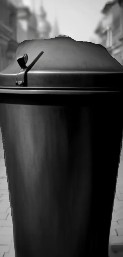 Black trash can on a quiet urban street, minimalistic and aesthetic view.