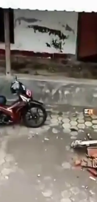 Motorcycle parked by a concrete wall with loose bricks nearby.