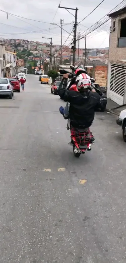 Motorcyclist performing a wheelie on an urban street, showcasing dynamic city life.