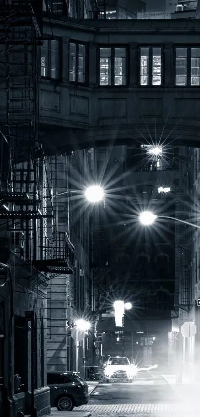 Monochrome alleyway at night with streetlights.