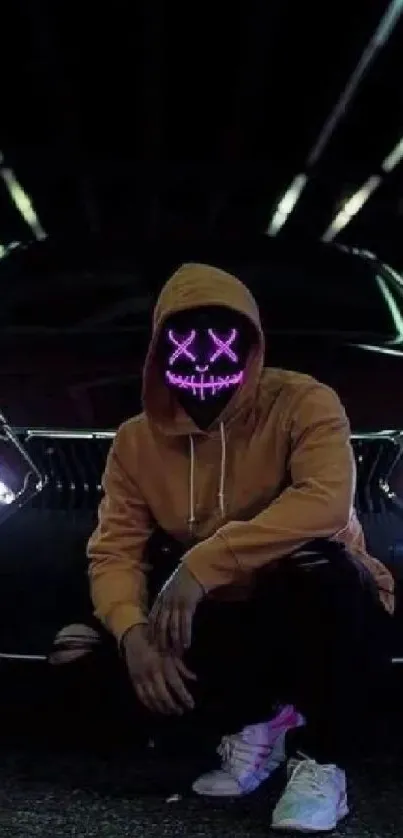 Masked figure crouching by a car under neon lights.