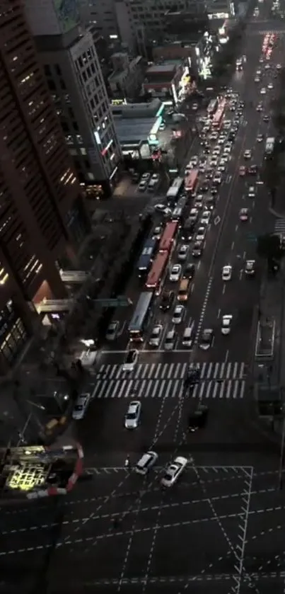 Aerial view of a bustling city street at night with vibrant lights.