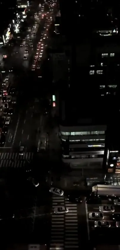 Night cityscape with lights and traffic, viewed from above.