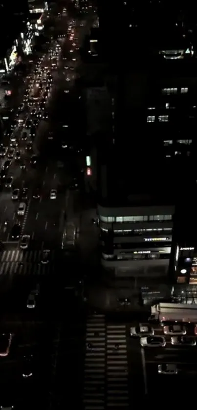 Aerial view of a bustling urban street illuminated at night.