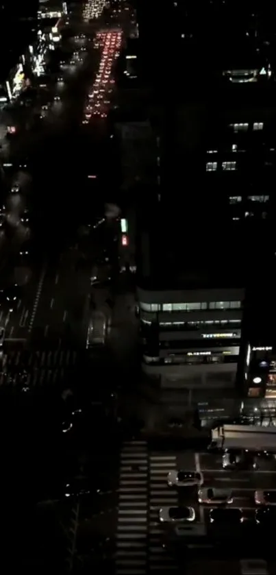 Aerial view of vibrant urban nightscape with city lights and busy streets.