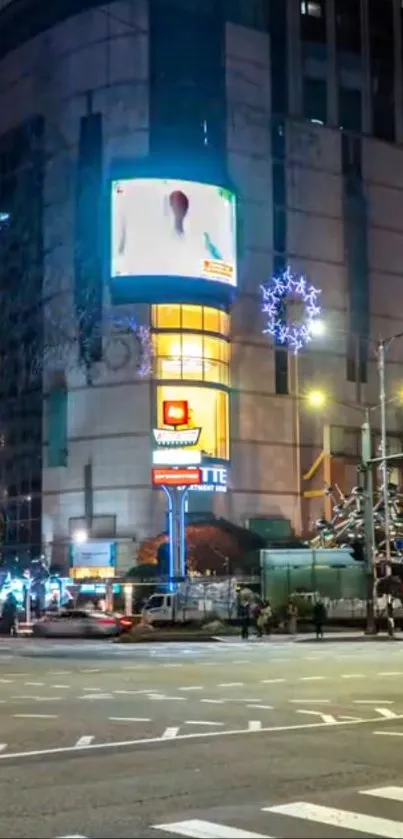 A vibrant urban street scene at night with bright city lights.