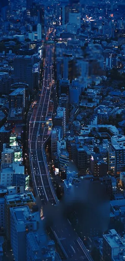 A deep blue cityscape with illuminated buildings at night.