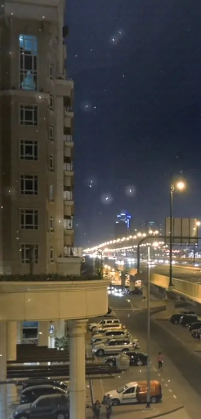 Urban city street view at night with lit buildings and road.