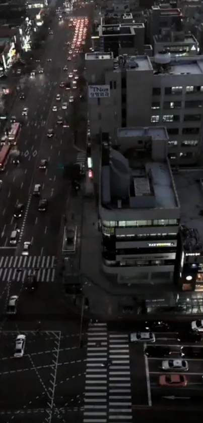 City street view at night with busy traffic and glowing lights.