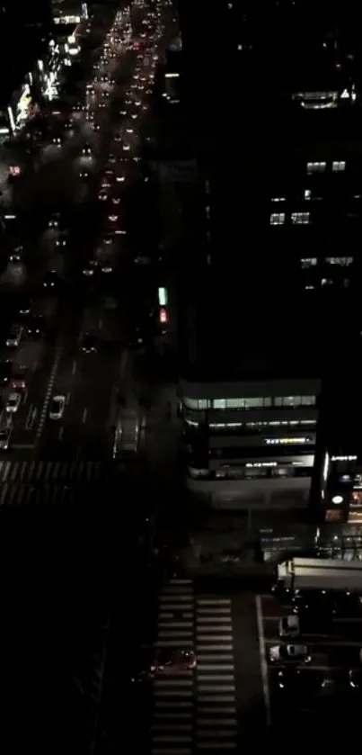 Aerial view of bustling city traffic at night with glowing lights.