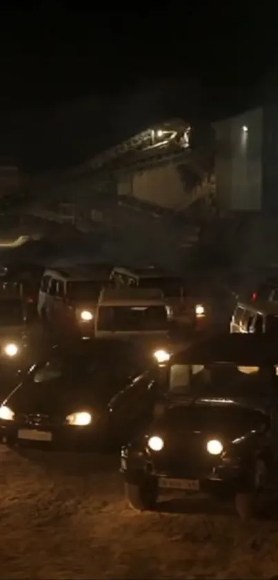 Urban night scene with vehicles parked in an industrial area.