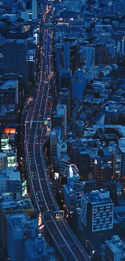 A vibrant cityscape at night with blue lights and tall buildings.