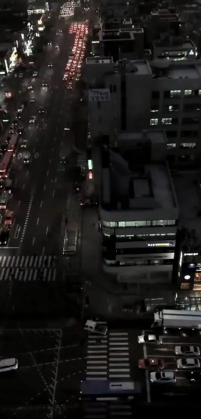 Nighttime view of a bustling city with glowing lights and busy streets.