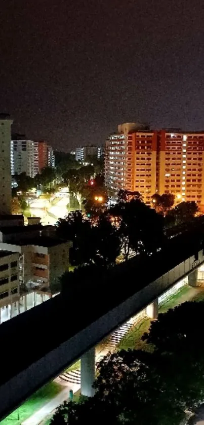 Night cityscape featuring illuminated buildings and streetlights.