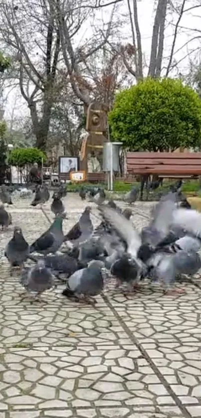 Flock of pigeons in a city park setting with trees and benches.