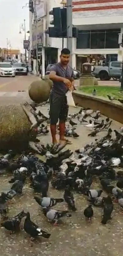 Man feeding pigeons in a bustling city street.