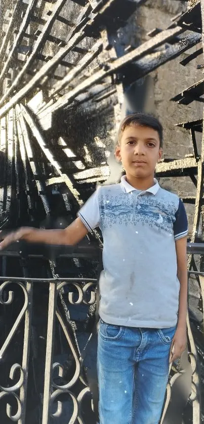 Young boy in front of a stylish metallic urban artwork.