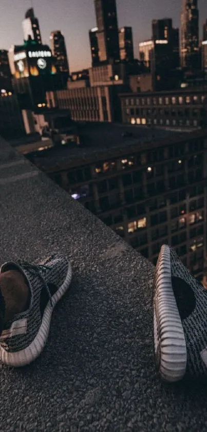 Rooftop view of cityscape with sneakers at night.