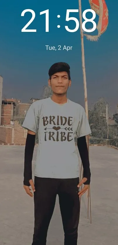 Young man on rooftop with cityscape background at dusk.