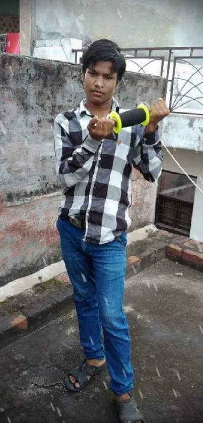 Young man kite flying on rooftop, urban style.