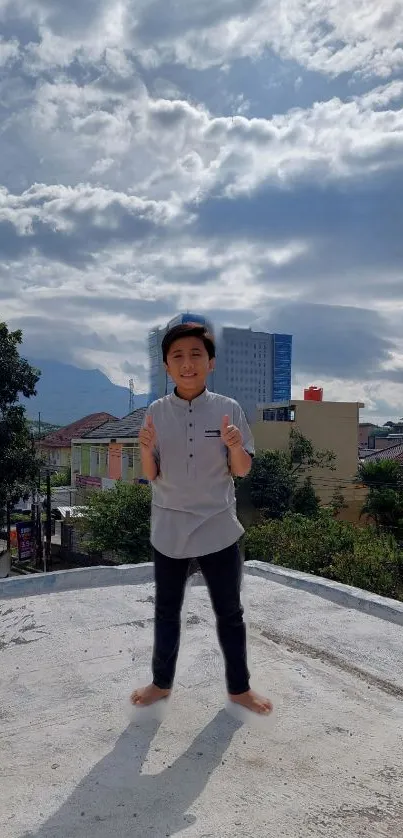 Kid stands on urban rooftop with sky in background.