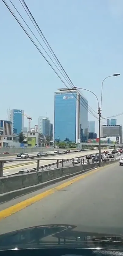 City skyline with highway under clear blue sky.