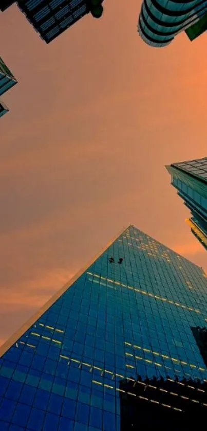 Urban skyline at sunset with tall skyscrapers and orange sky.