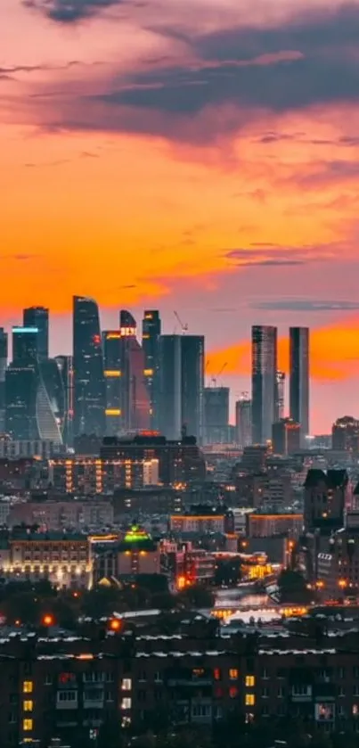 Sunset over an urban skyline with skyscrapers and orange sky.