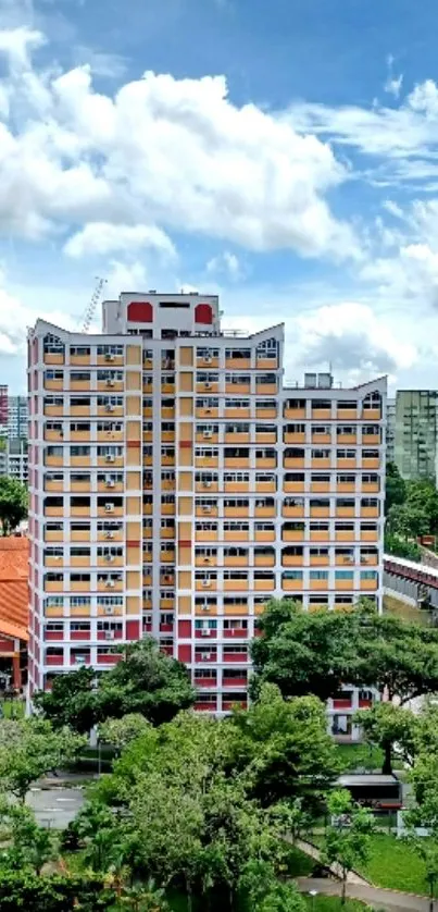 Colorful urban apartment building with blue sky and green park.